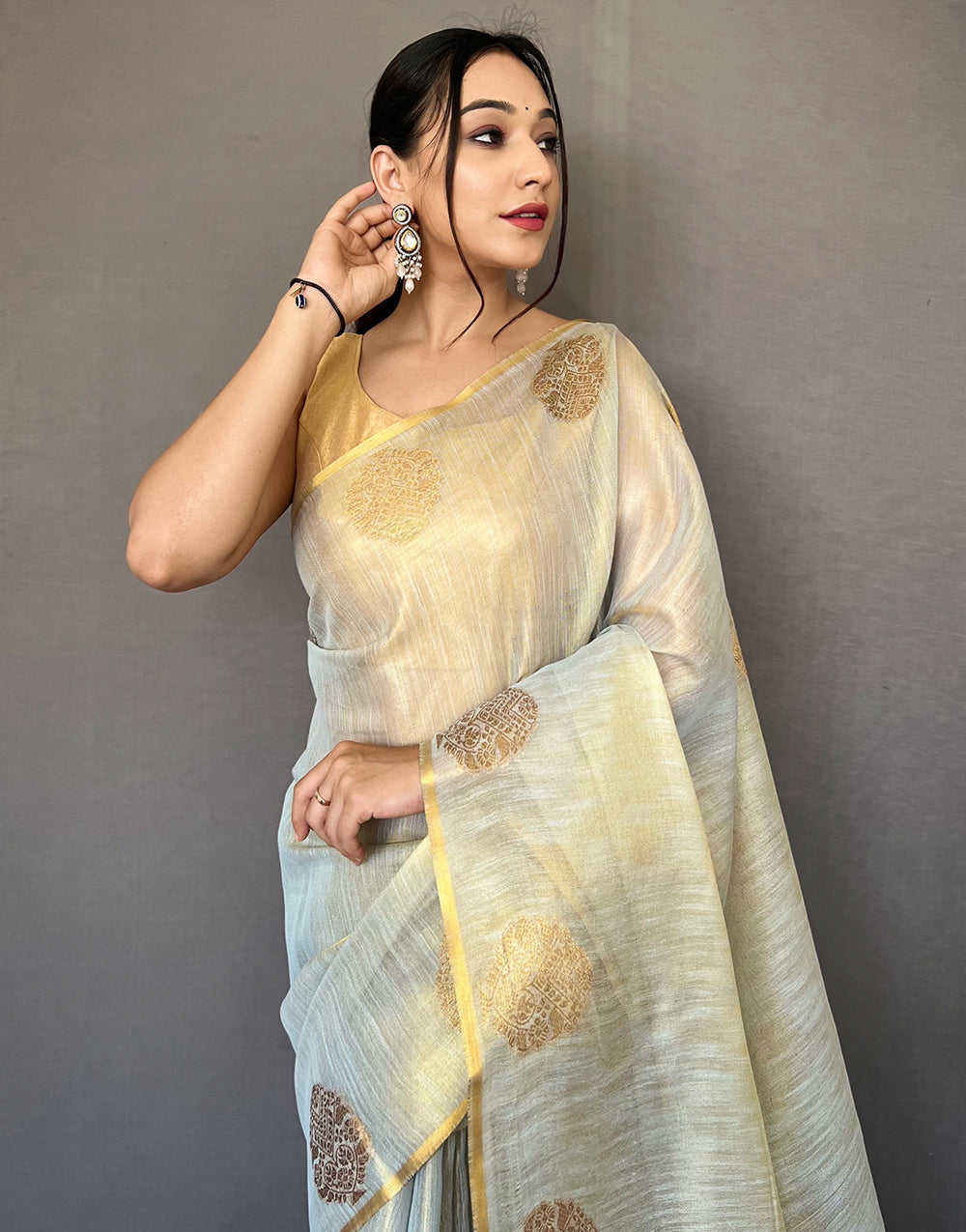 Cream Tissue Silk Saree With Zari Weaving Work