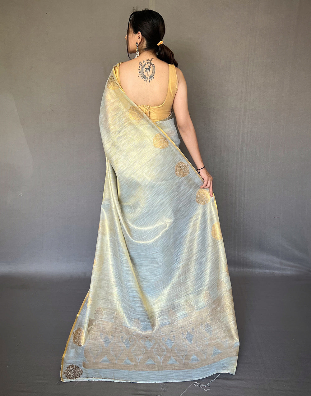 Cream Tissue Silk Saree With Zari Weaving Work